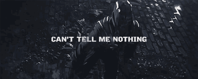 a man standing on a cobblestone street with the words " can 't tell me nothing " behind him