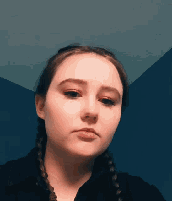 a girl with braids is looking at the camera