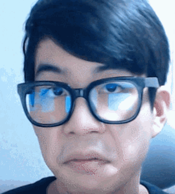 a man wearing glasses makes a funny face