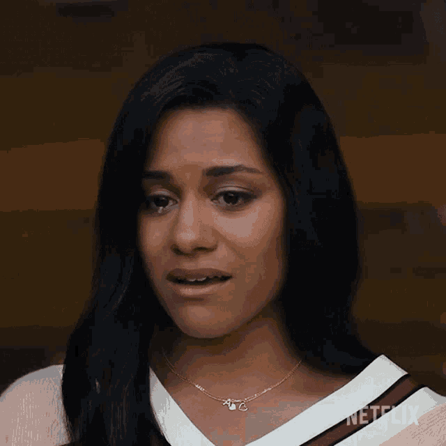 a woman with her eyes closed is wearing a necklace that says netflix