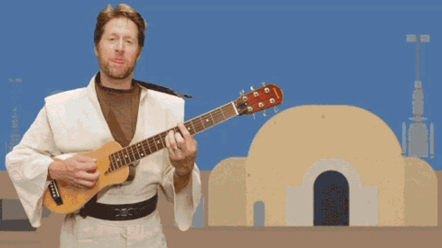 a man playing a guitar with a yamaha logo on it