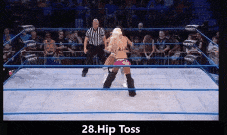 two women are wrestling in a wrestling ring with a referee in the background ..
