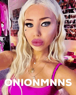 a blonde woman in a pink tank top is taking a selfie with the words onionmnns below her
