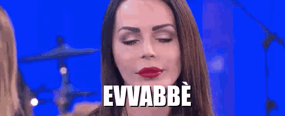 a woman is making a funny face with her eyes closed and the word evvabbe is written on her face .