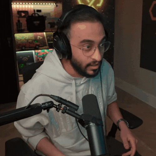 a man with a beard wearing headphones and glasses