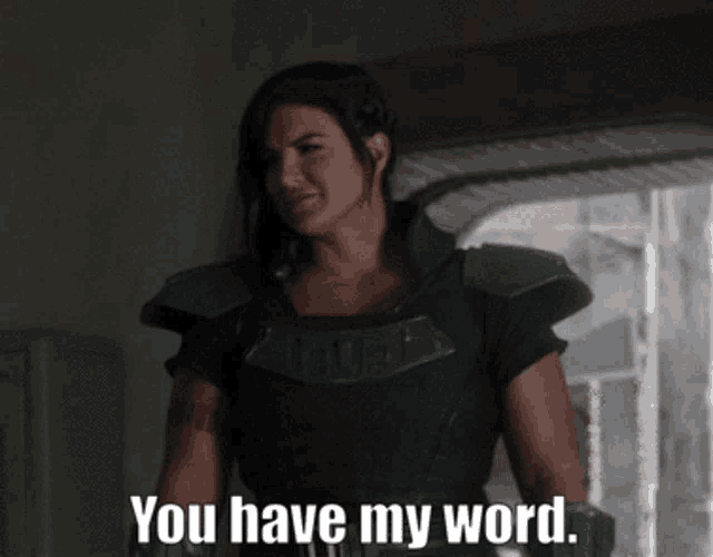a woman says " you have my word " while standing in a hallway