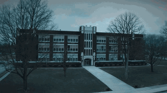 a large brick building with a clock on the front