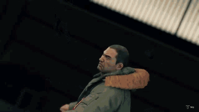 a man in a red suit is sitting on a wooden floor in a video game .