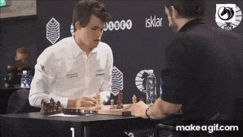 two men are playing a game of chess with a make a gif.com advertisement in the background