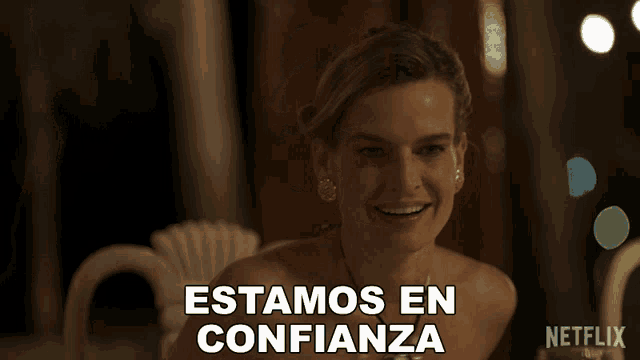 a woman sitting at a table with the words estamos en confianza above her