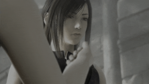a black and white photo of a girl with a serious look on her face