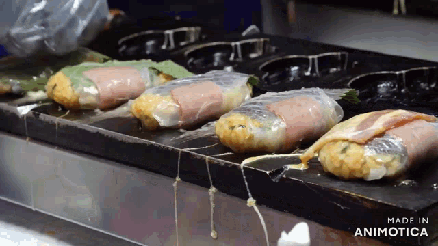 a bunch of food being cooked on a grill with the words made in animotica