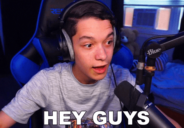 a young man wearing headphones and a blue microphone says hey guys