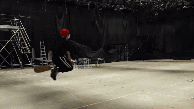a man in a red hat jumps in the air