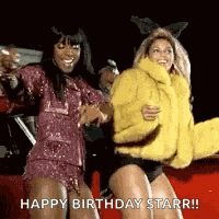 two women are dancing in front of a red car with the words `` happy birthday starr '' .