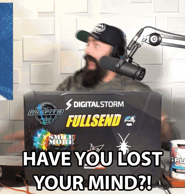 a man sitting in front of a laptop that says digitalstorm fullsend