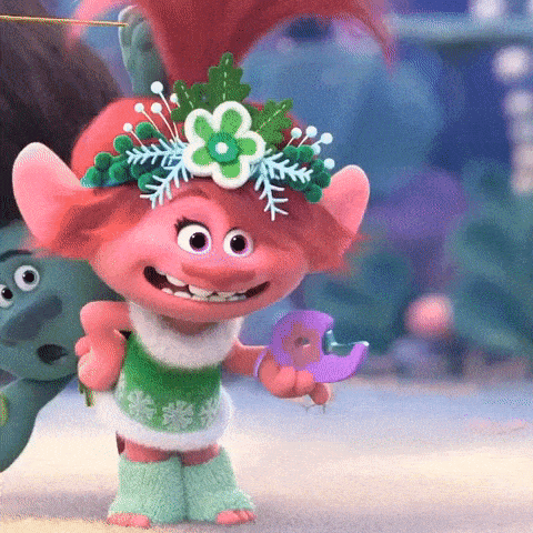 poppy from trolls is wearing a flower crown and holding a bird .