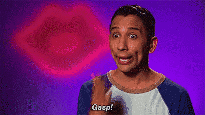 a man is blowing a kiss and saying gasp in front of a pink lip .