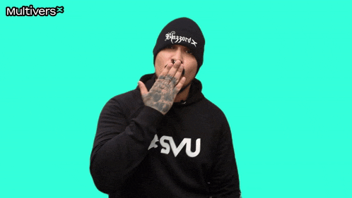 a man wearing a beanie with the word blizzard on it holds out his hand