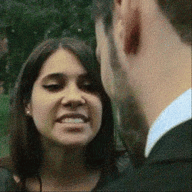 a man and a woman are looking into each other 's eyes