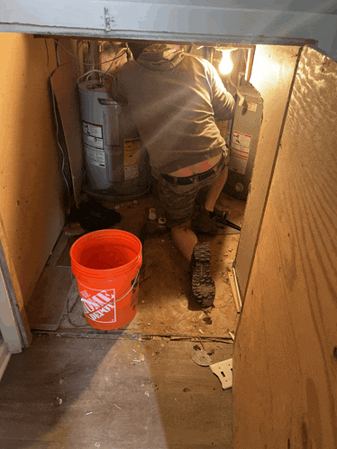 an orange bucket that says home depot sits on the floor