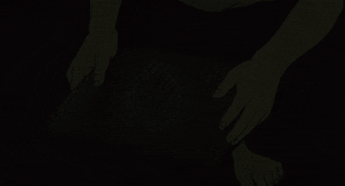 a person reaching into a pot of fireflies