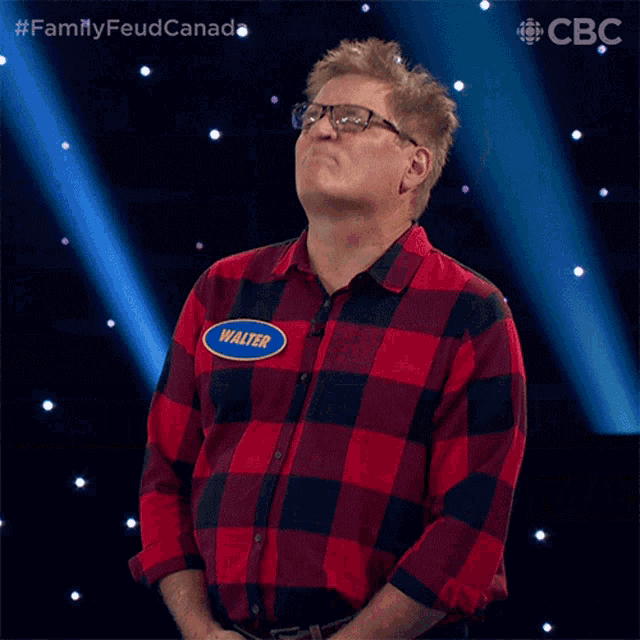 a man in a plaid shirt has a name tag that says walter on it