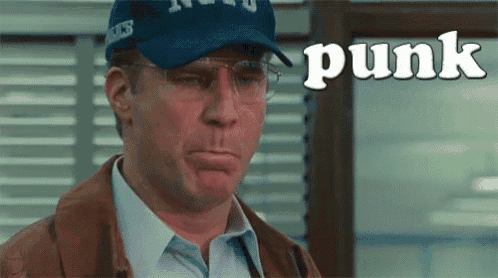 a man wearing glasses and a hat with the word punk on it .