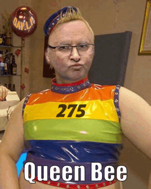 a man is wearing a rainbow colored top with the number 275 on it