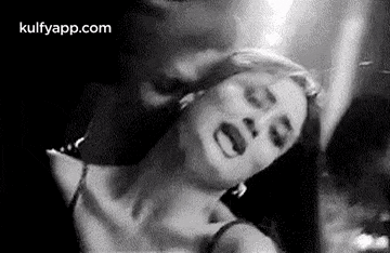 a black and white photo of a woman making a face .