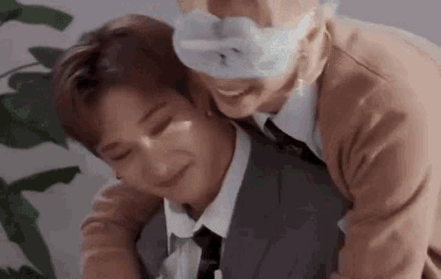 a man in a suit and tie is giving a woman a piggyback ride .