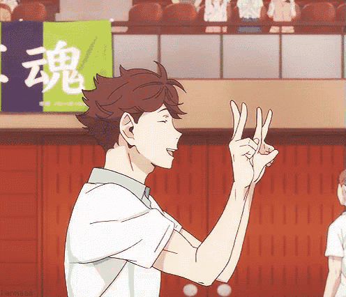a man is making a peace sign with his fingers