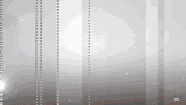 a gray background with a row of pearls on it .