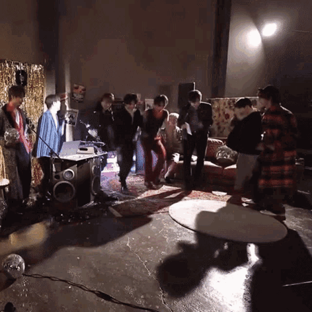 a group of people standing around a drum set in a living room