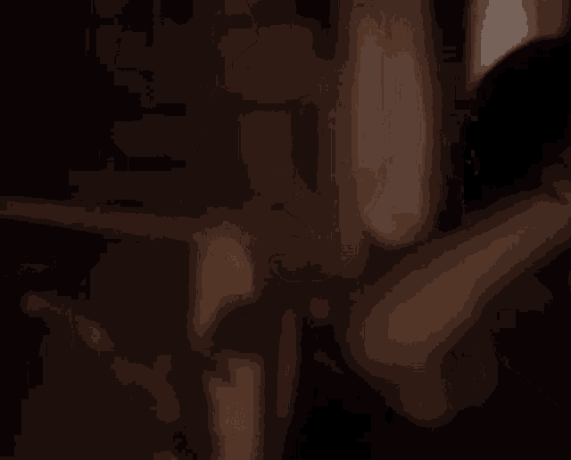 a close up of a person 's arm in a dark room in a blurry photo .