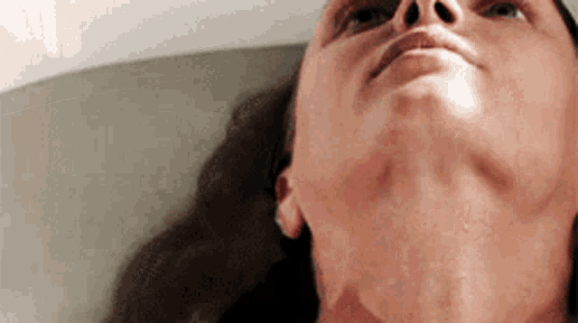 a close up of a woman 's face with her eyes closed
