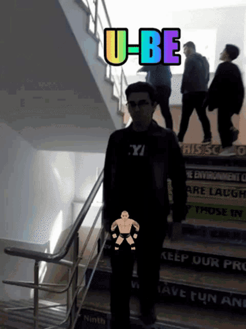 a man standing on a set of stairs with the words u-be on top of him