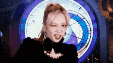 a woman is making a funny face in front of a clock .