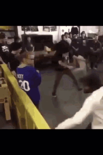 a man wearing a blue jersey with the number 20 on it is fighting another man
