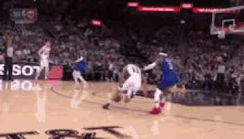 a basketball game is being played in front of a crowd and a sign that says los angeles