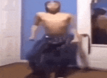 a man without a shirt is standing in a doorway .