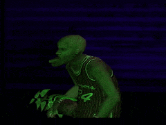 a man wearing a striped tank top is glowing green