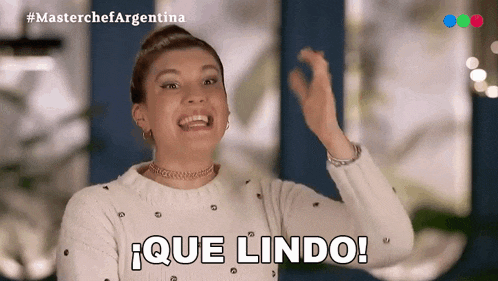 a woman in a white sweater says " que lindo " in spanish