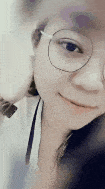 a close up of a woman 's face with glasses