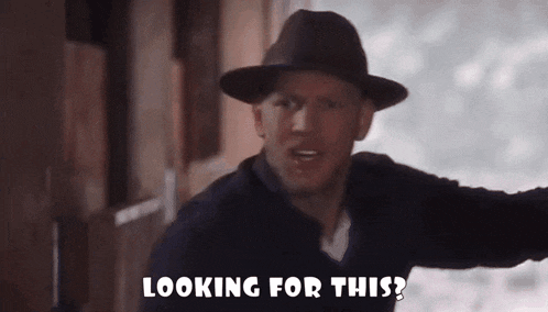a man in a hat is looking for something and says looking for this .