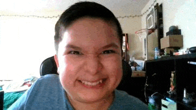 a young boy is making a funny face while sitting in a chair in front of a basketball hoop .