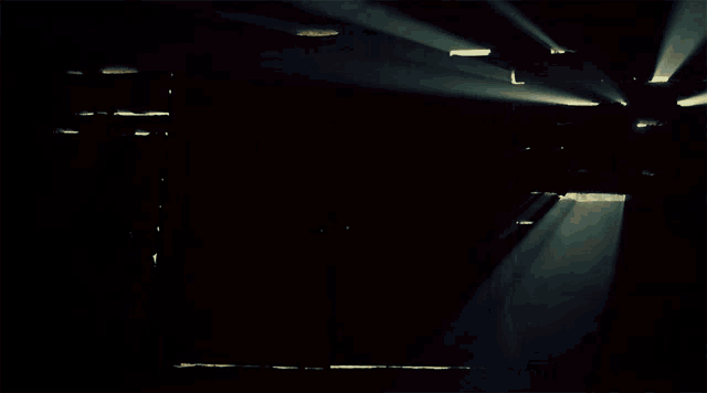 a woman is walking through a doorway with the sun shining through it