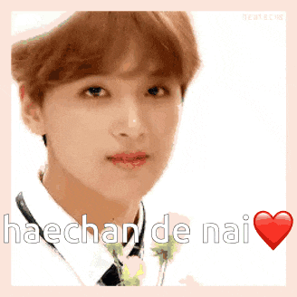 a close up of a young man 's face with the words haechan de nai written on it .