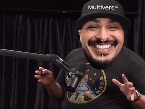 a man wearing headphones is smiling in front of a microphone .