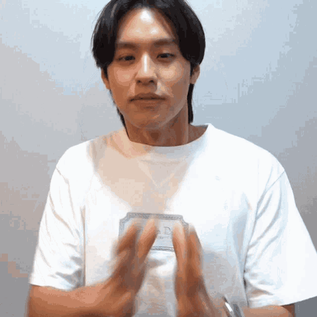 a young man wearing a white t-shirt with the word ad on it